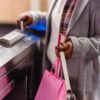 woman passing through checking electronic turnstile in subway