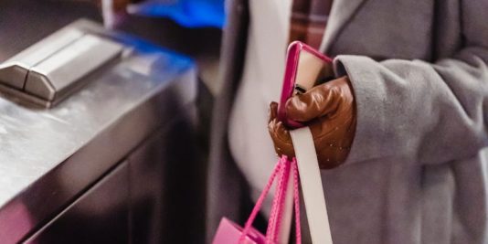 woman passing through checking electronic turnstile in subway